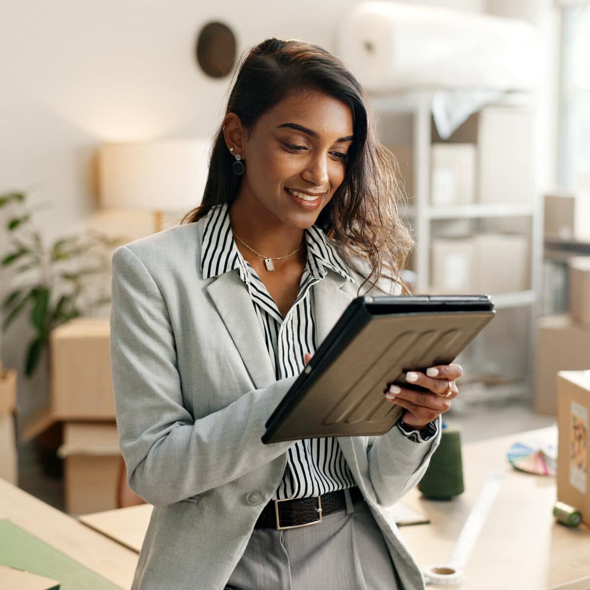 Small business, woman and tablet for e commerce, startup and inventory management of online shop, order or courier. Entrepreneur or Indian seller on digital technology for logistics, boxes or package